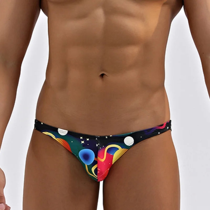 Colorful men's underwear with space-themed design on a plain background