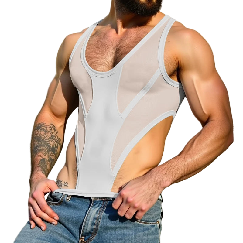 Man wearing a white tank top and blue jeans against a beige wall