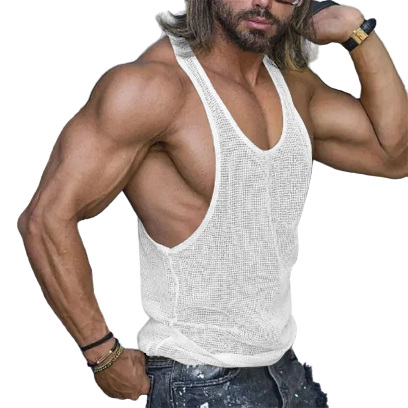 Muscular man wearing a white tank top with a blurred background