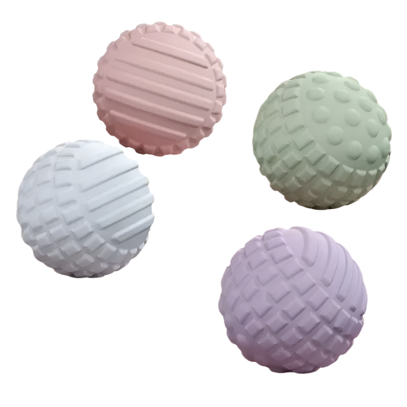 Four textured balls in pastel colors on a pink platform with a soft pink background